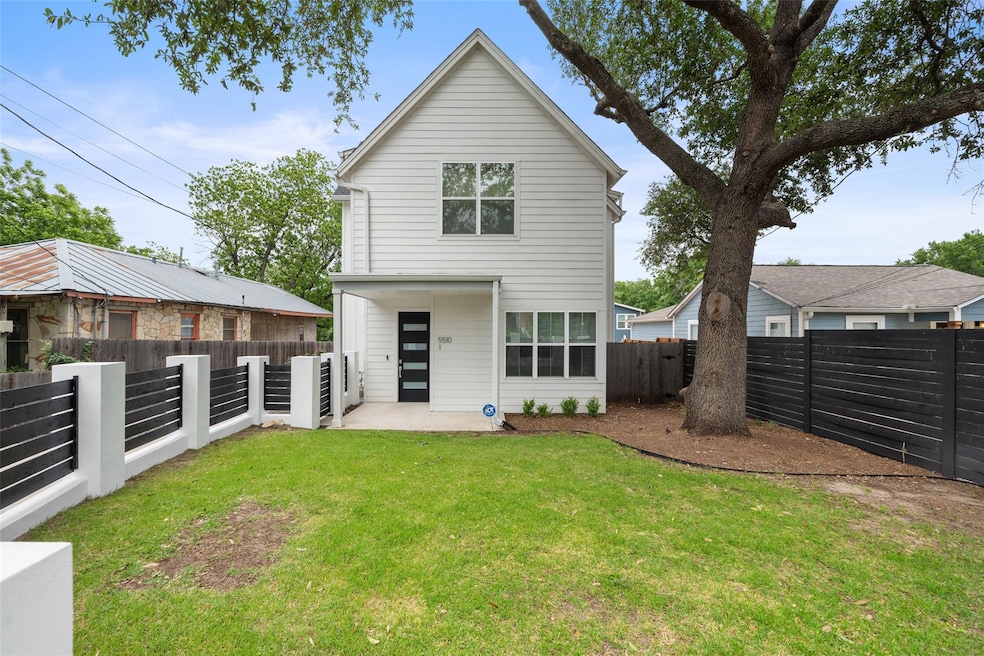 Back of house with a yard, a fenced backyard, and