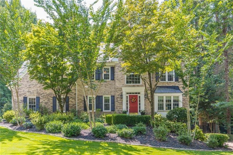 Beautiful 3 sided brick home with lush landscaping
