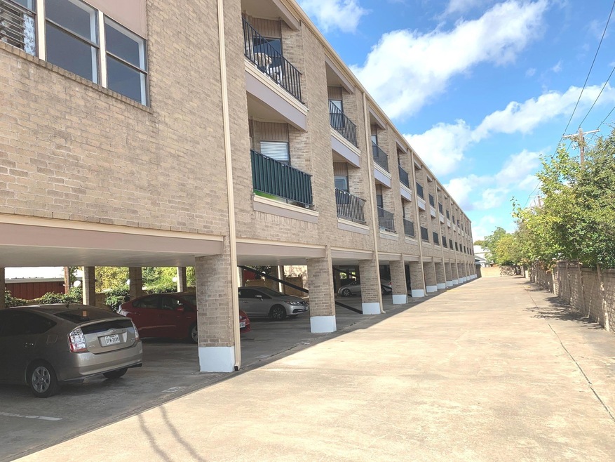 View of property featuring covered parking
