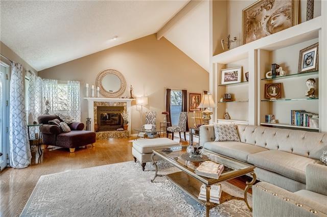 Enter to the warm, inviting family room with wood 