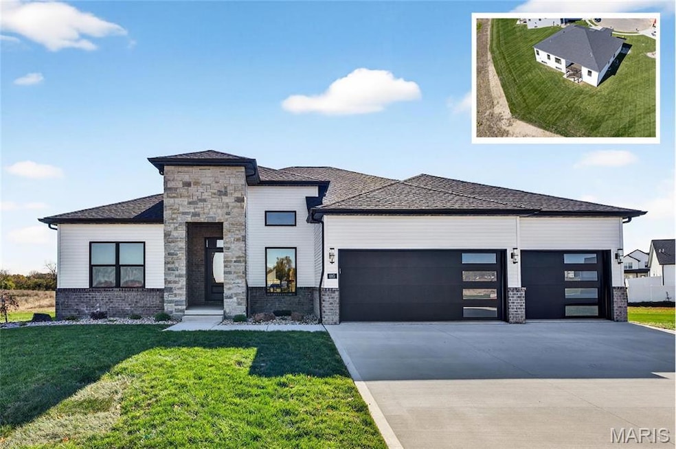 View of front facade with a front lawn, a garage, driveway, and a shingled roof