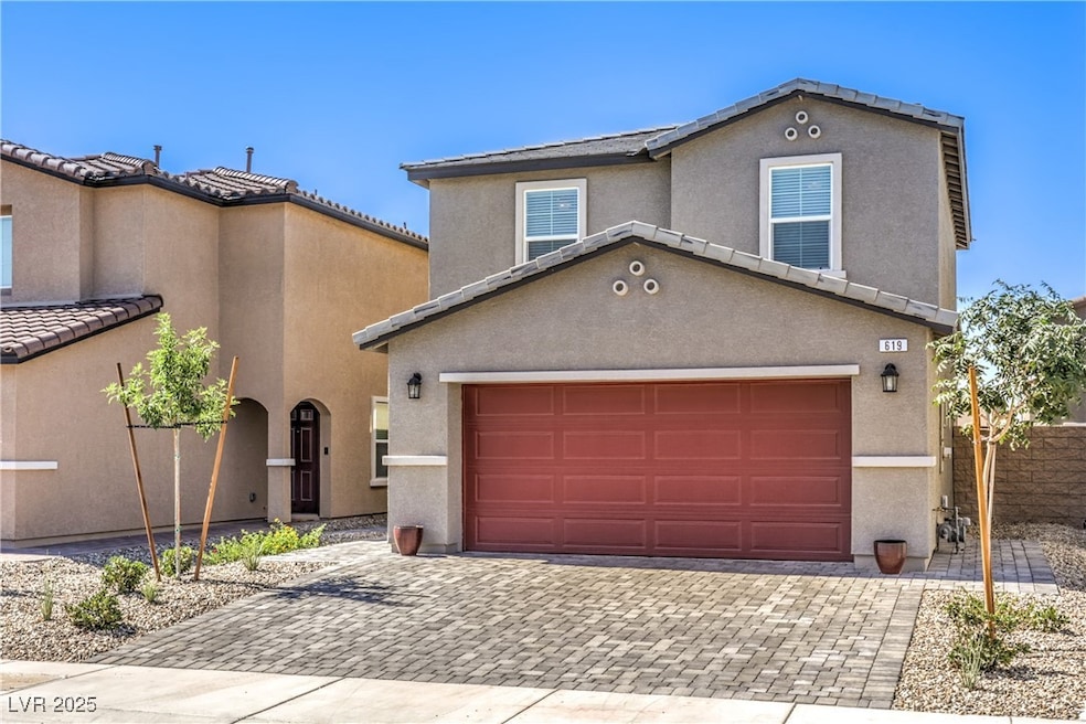 View of front facade with decorative driveway and
