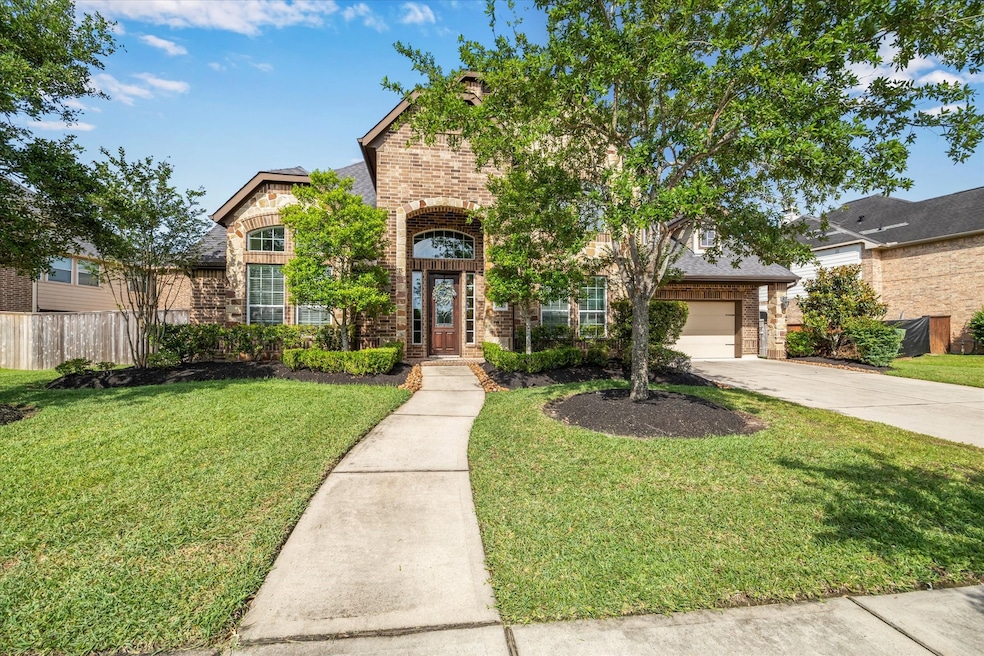 A welcoming pathway leads to an elegant entryway,