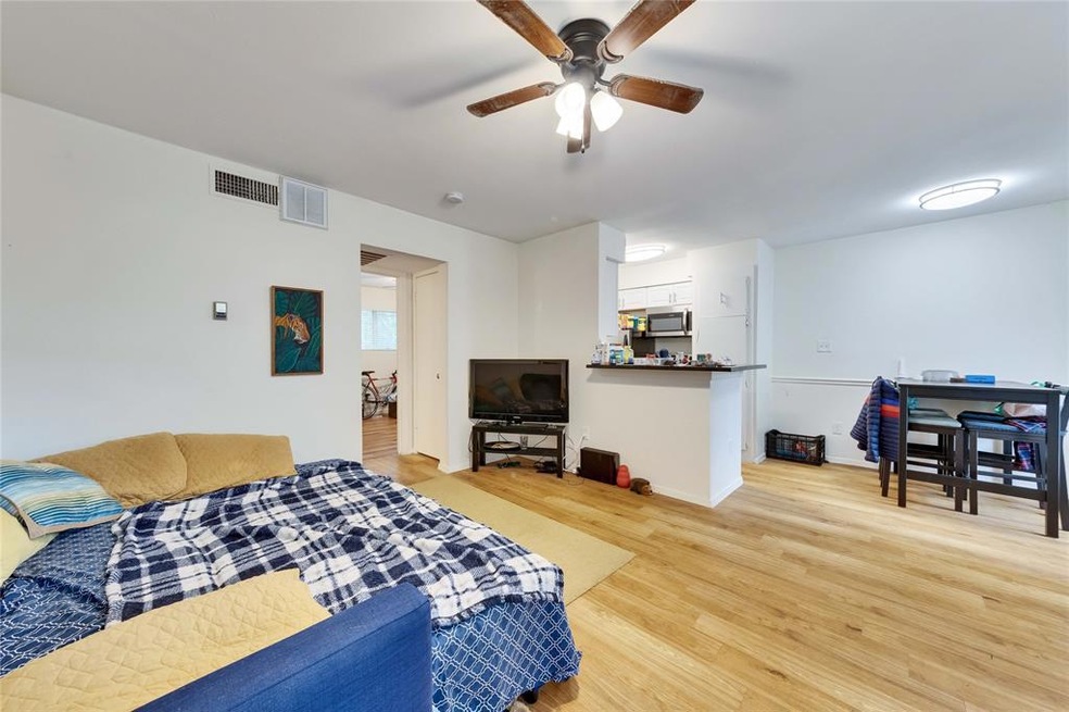 Bright, open living room flows to kitchen, bar and