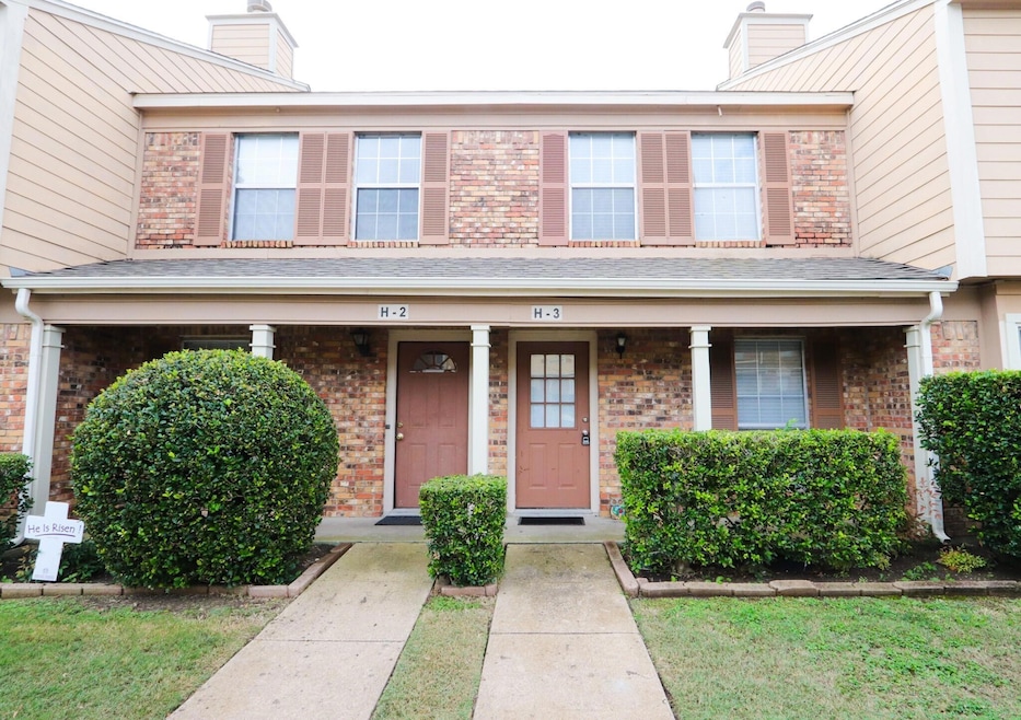 View of front facade featuring a chimney, brick si