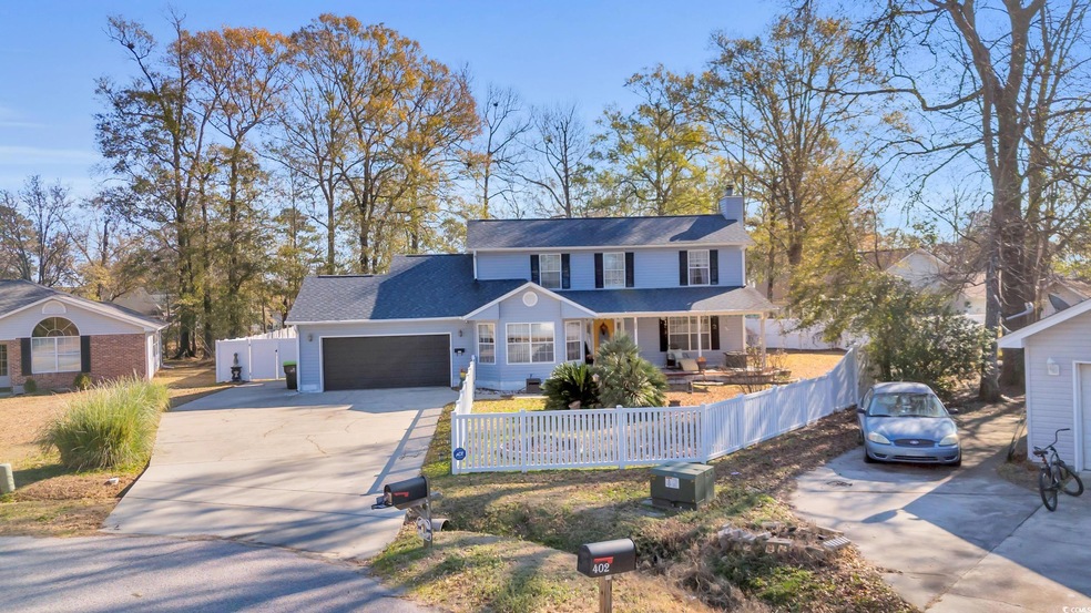 View of front of property featuring a garage and c