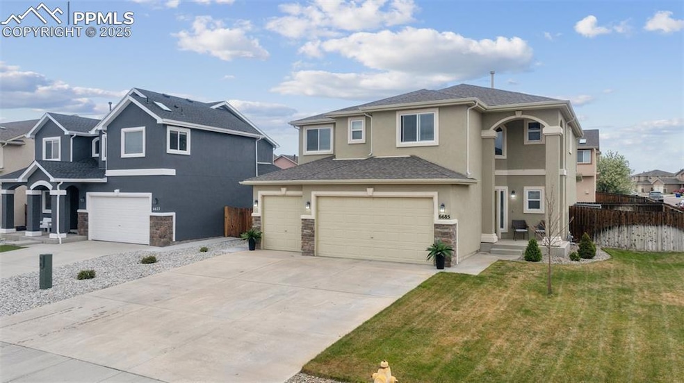 Traditional home with fence, stone accent siding, 