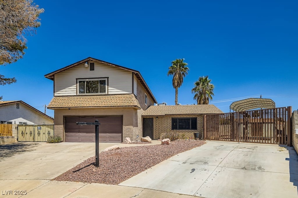 Traditional home with concrete driveway, a gate, a