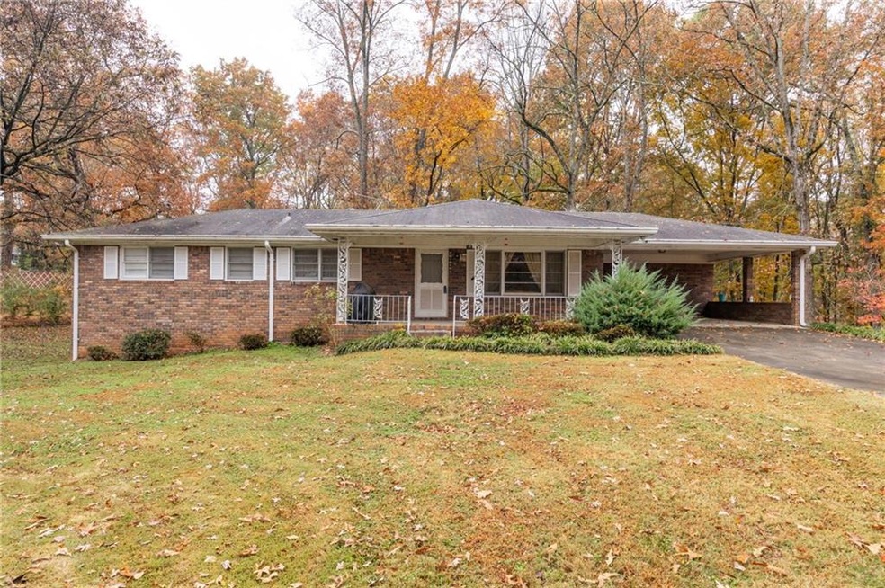 Single story home featuring a front lawn, a porch,