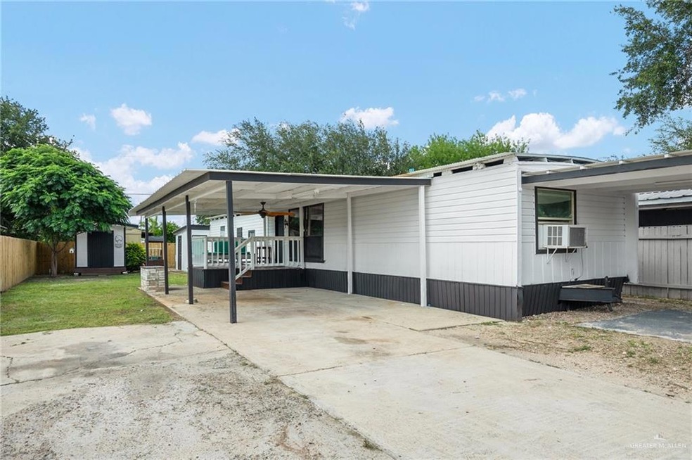 View of home's exterior featuring a lawn, a carport and covered patio with ceiling fan.