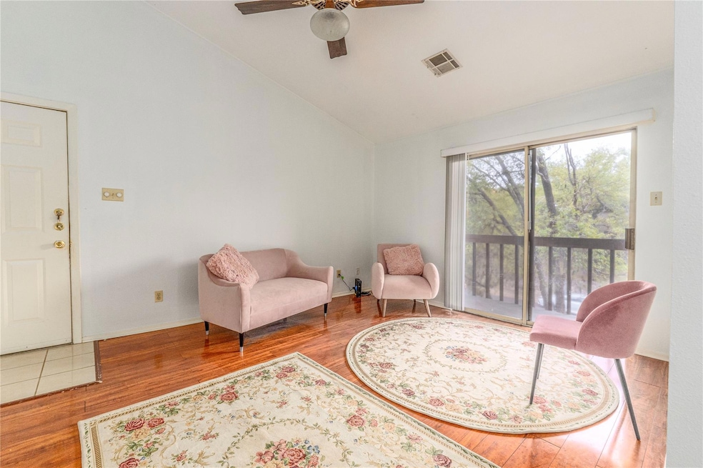 Sitting room featuring a ceiling fan, wood finish