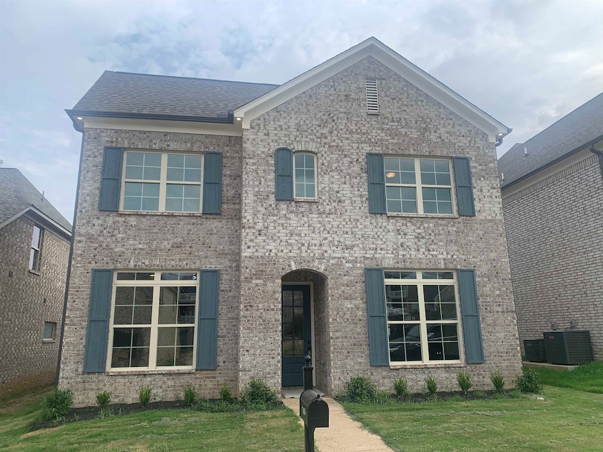 Front Ext featuring a front lawn, brick siding, and a shingled roof
