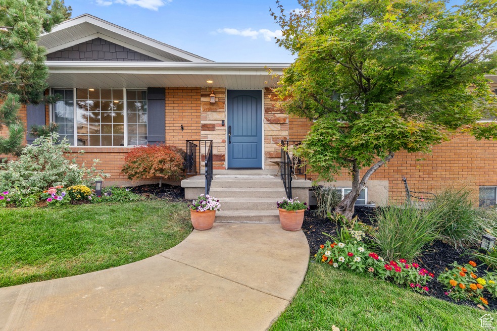 View of front facade with brick siding and a front lawn