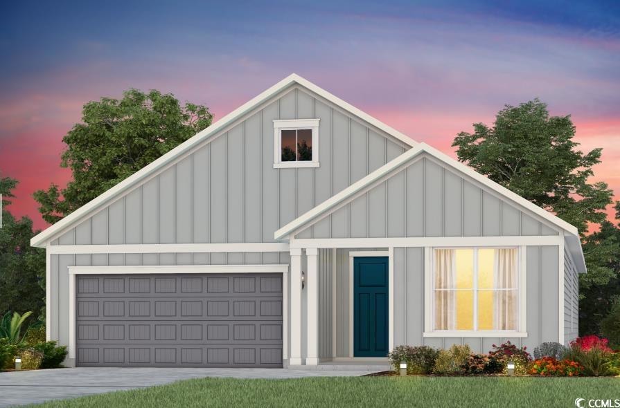 Modern farmhouse style home featuring board and batten siding and driveway