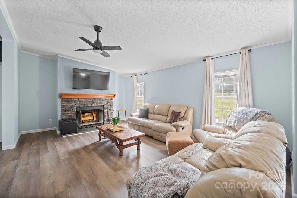 Family room with cozy wood burning fireplace is located right off of the Kitchen!