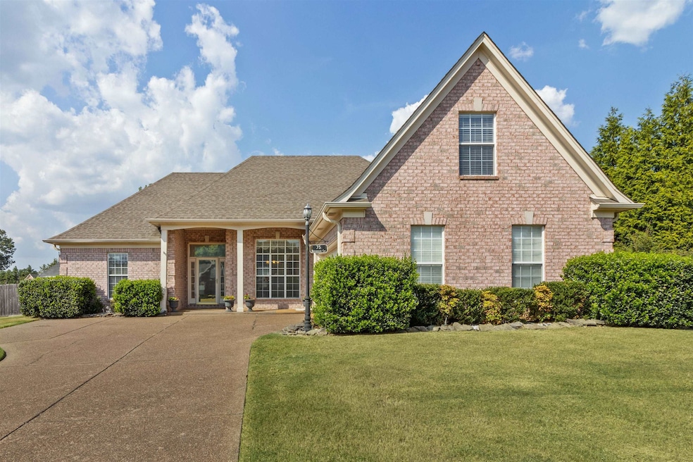 Traditional home featuring a front lawn, brick siding, a shingled roof, and a porch