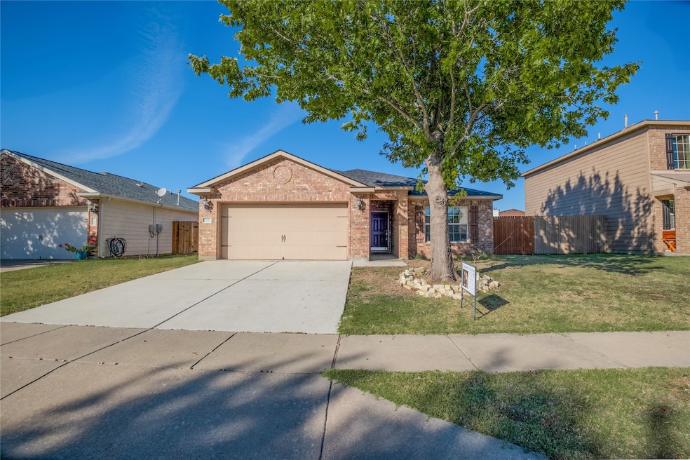 Single story home with concrete driveway, brick siding, and an attached garage