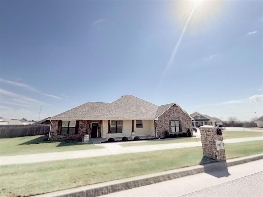 Ranch-style home with a front yard, fence, brick s
