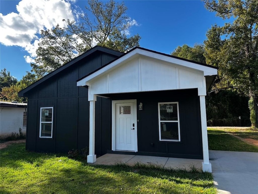 View of front of house with a porch and a front lawn