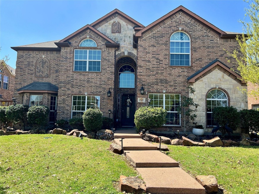 View of front of property with stone siding, brick