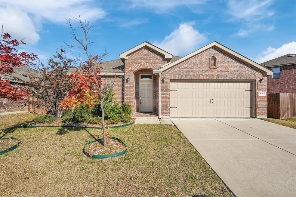 View of front of house featuring a front yard and a garage