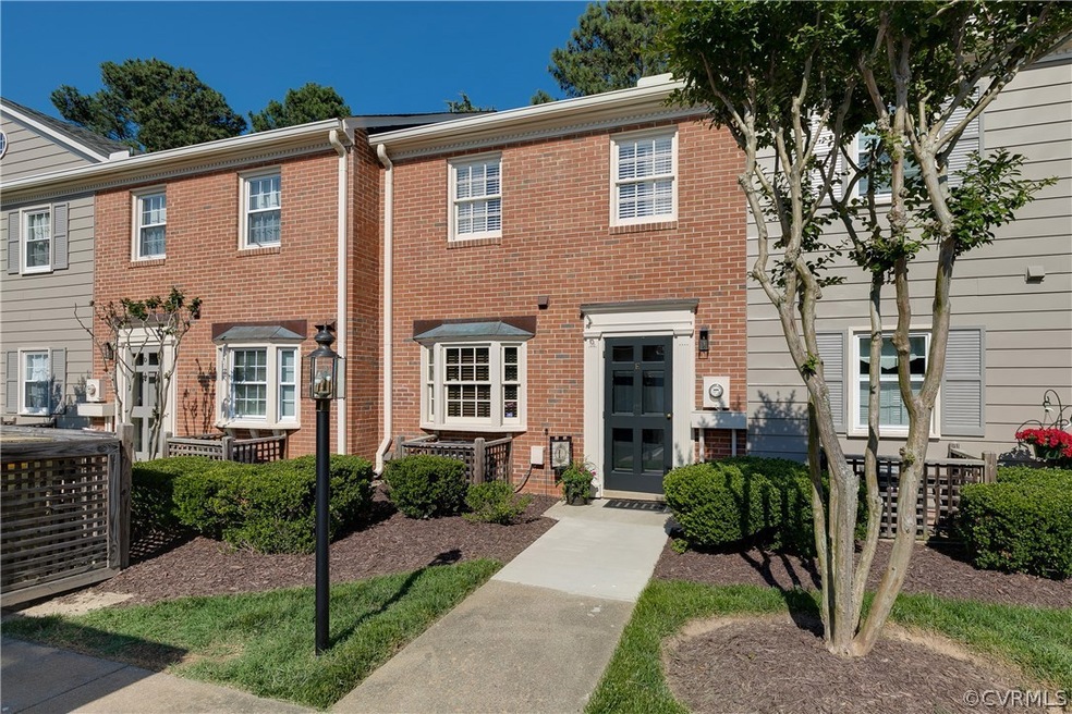 All brick two-story condo with parking spaces righ