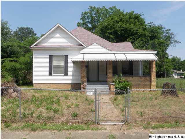 Front elevation with empty lot on left and right.