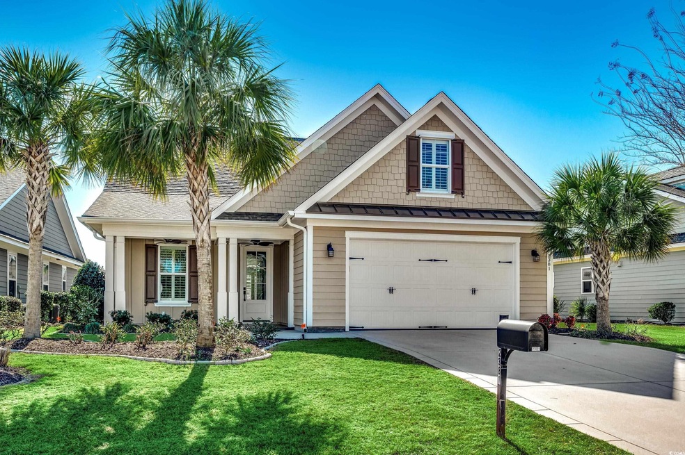 View of front of house with a front lawn and a gar