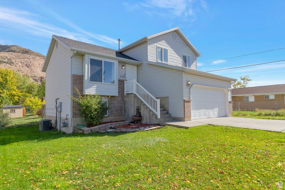 Split level home featuring brick siding and driveway