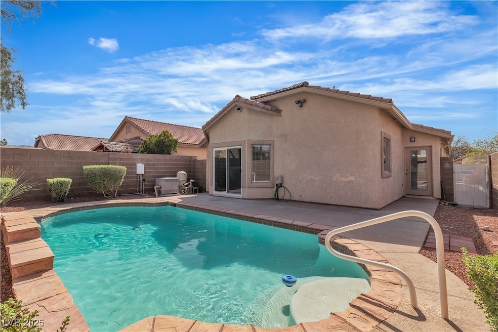 View of swimming pool with a patio area and a fenc