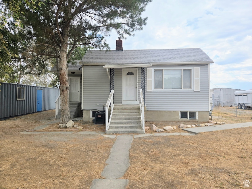 Bungalow featuring a chimney and a shingled roof
