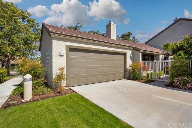 Garage is large and has storage shelves and water 