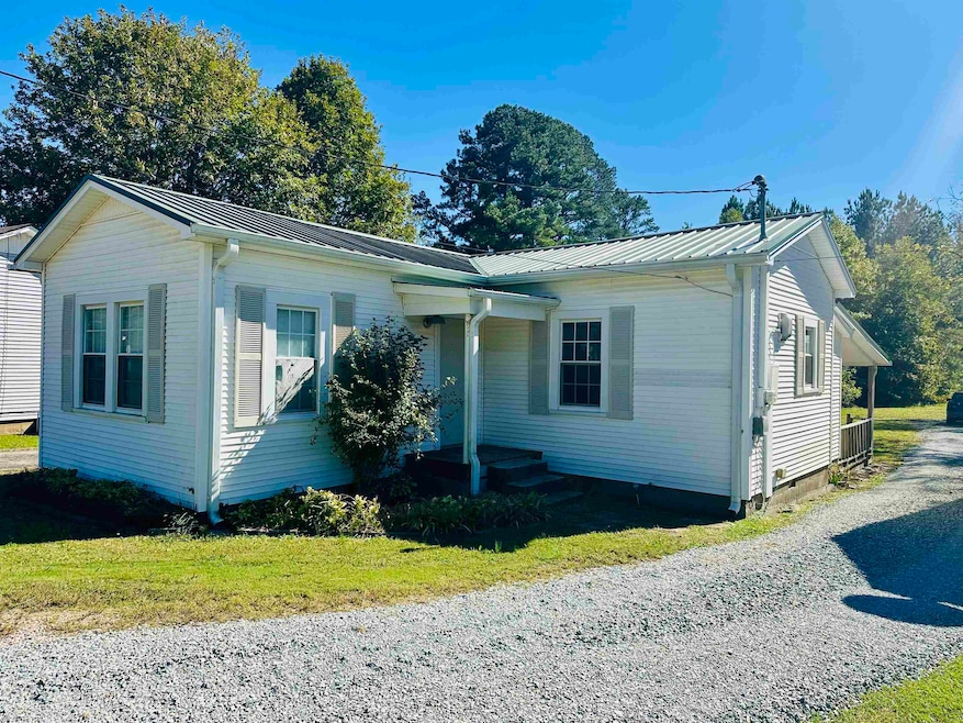 Bungalow-style home featuring a metal roof, a front lawn, and crawl space