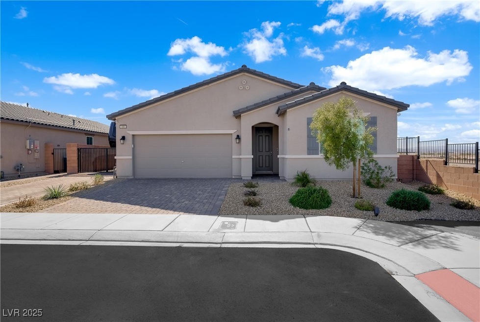 Mediterranean / spanish-style home featuring a gar