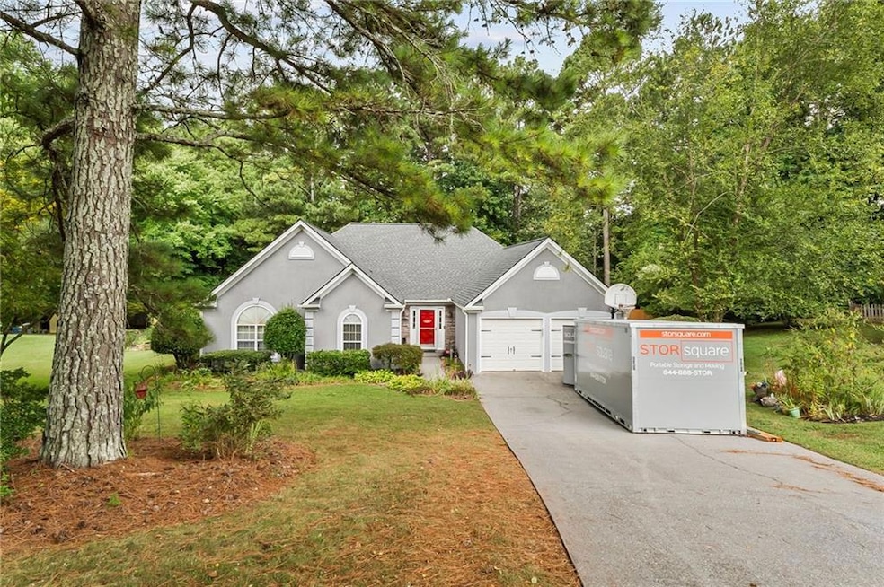 Single story home with stucco siding, concrete driveway, a shingled roof, a front lawn, and a garage