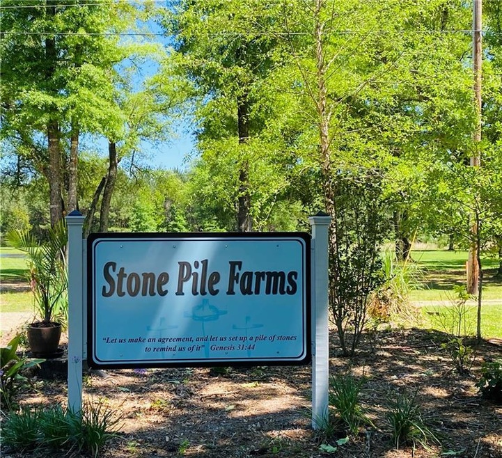 Sign at property entrance down a long driveway.