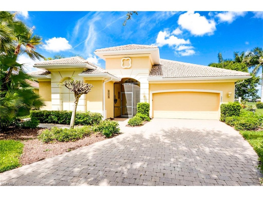 Welcoming paver driveway and screened entry.