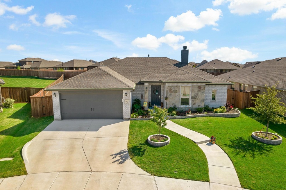 View of front of home featuring a garage and a front lawn