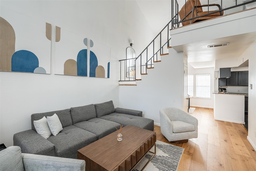 Living room with light hardwood / wood-style floor