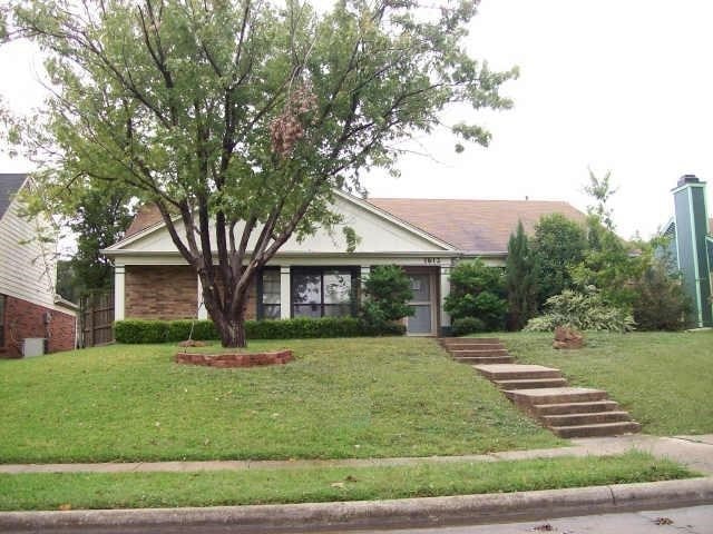 View of front of property featuring a front lawn and brick siding