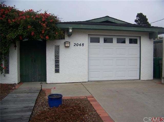 Stucco home with newer roof and private court yard