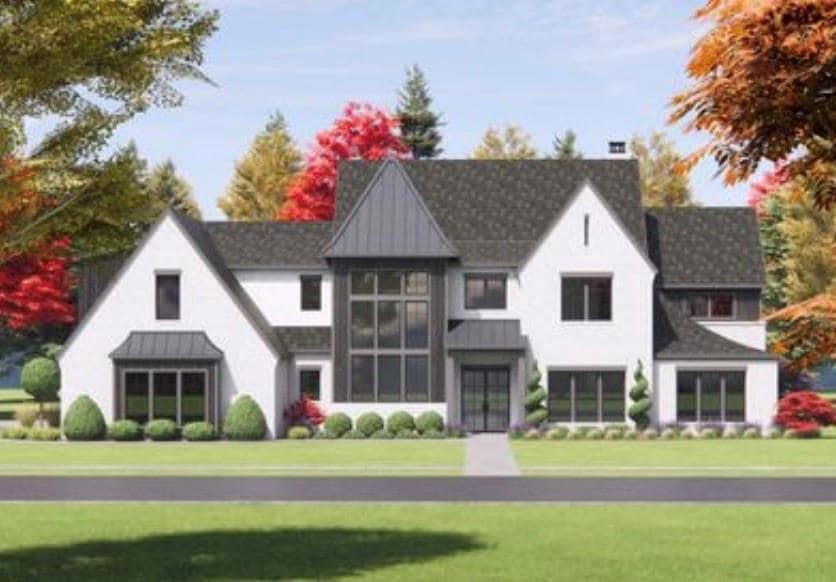 Back of house with a standing seam roof, a metal roof, a chimney, and a yard