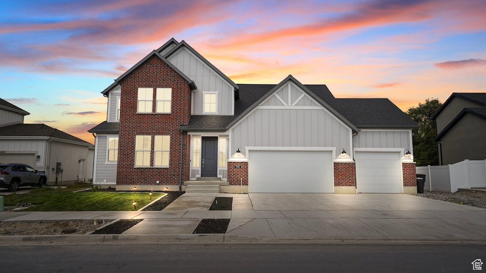 View of front of house featuring board and batten siding, concrete driveway, and a garage