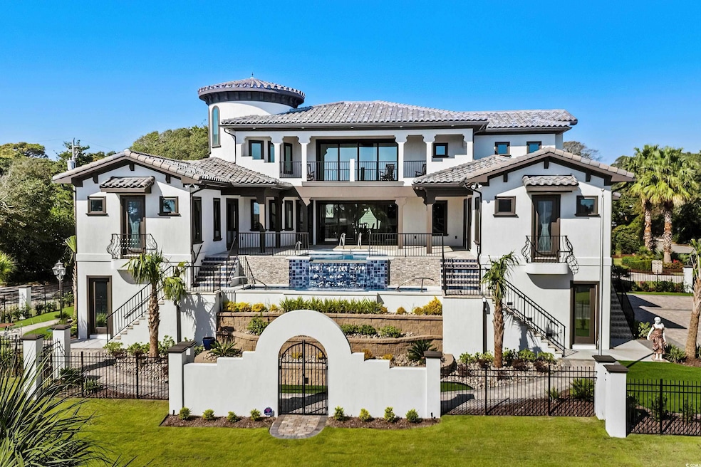Rear view of property with a yard and a balcony