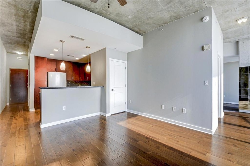 Unfurnished living room featuring hardwood / wood
