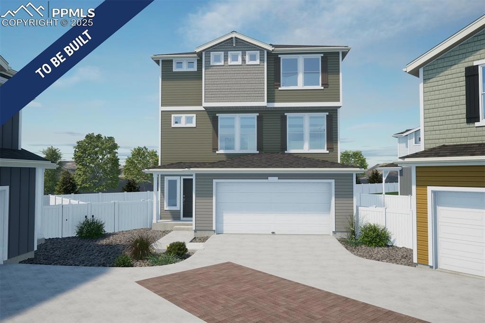 View of front facade featuring a garage