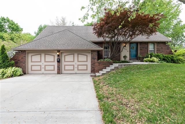 The front features brick trim, softer landscaping,