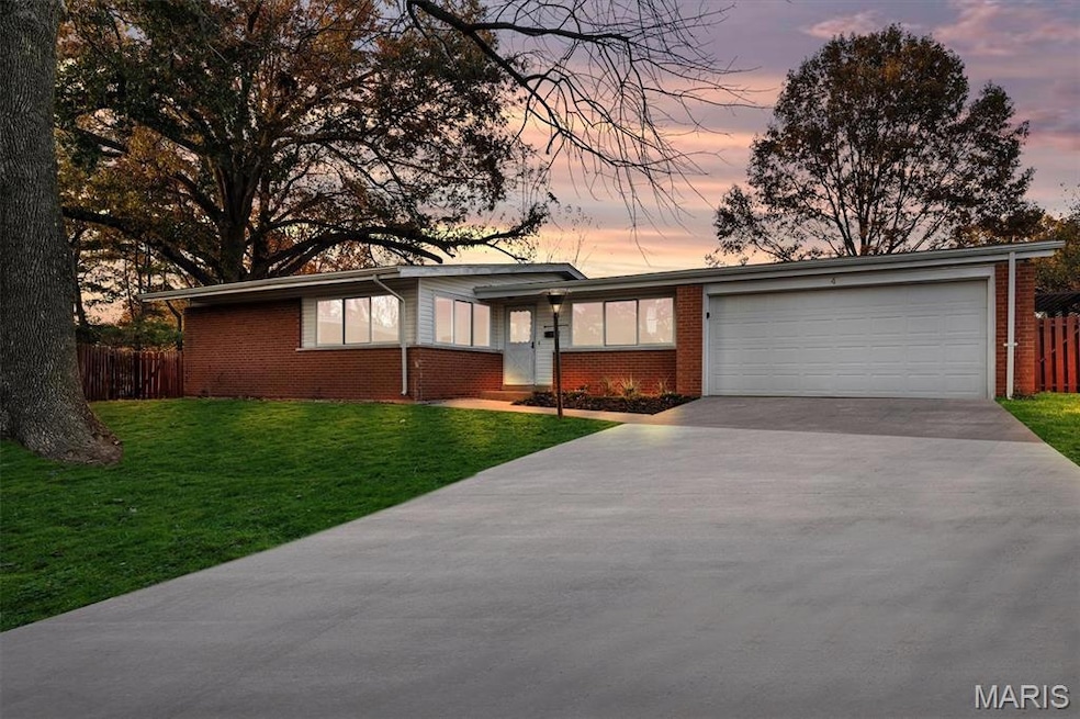 View of front of property with concrete driveway and brick siding