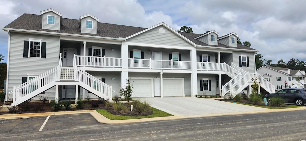 View of front of house with a garage and a porch