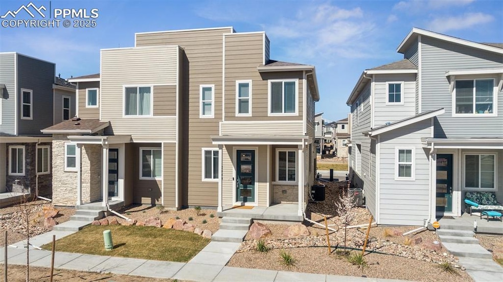 Front of modern townhome featuring beautiful lands